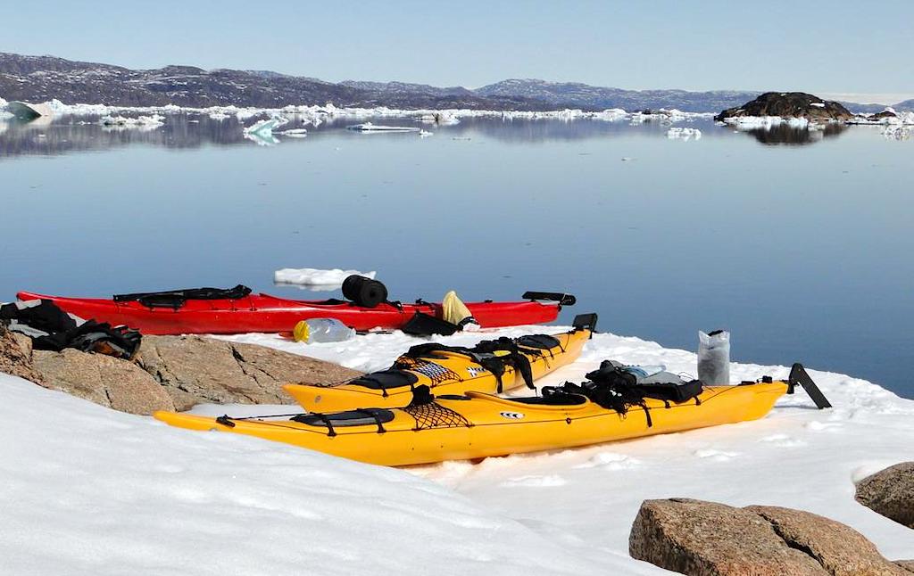 Three kayaks in the Upernavik Archipelago, located in the northeast of Greenland.